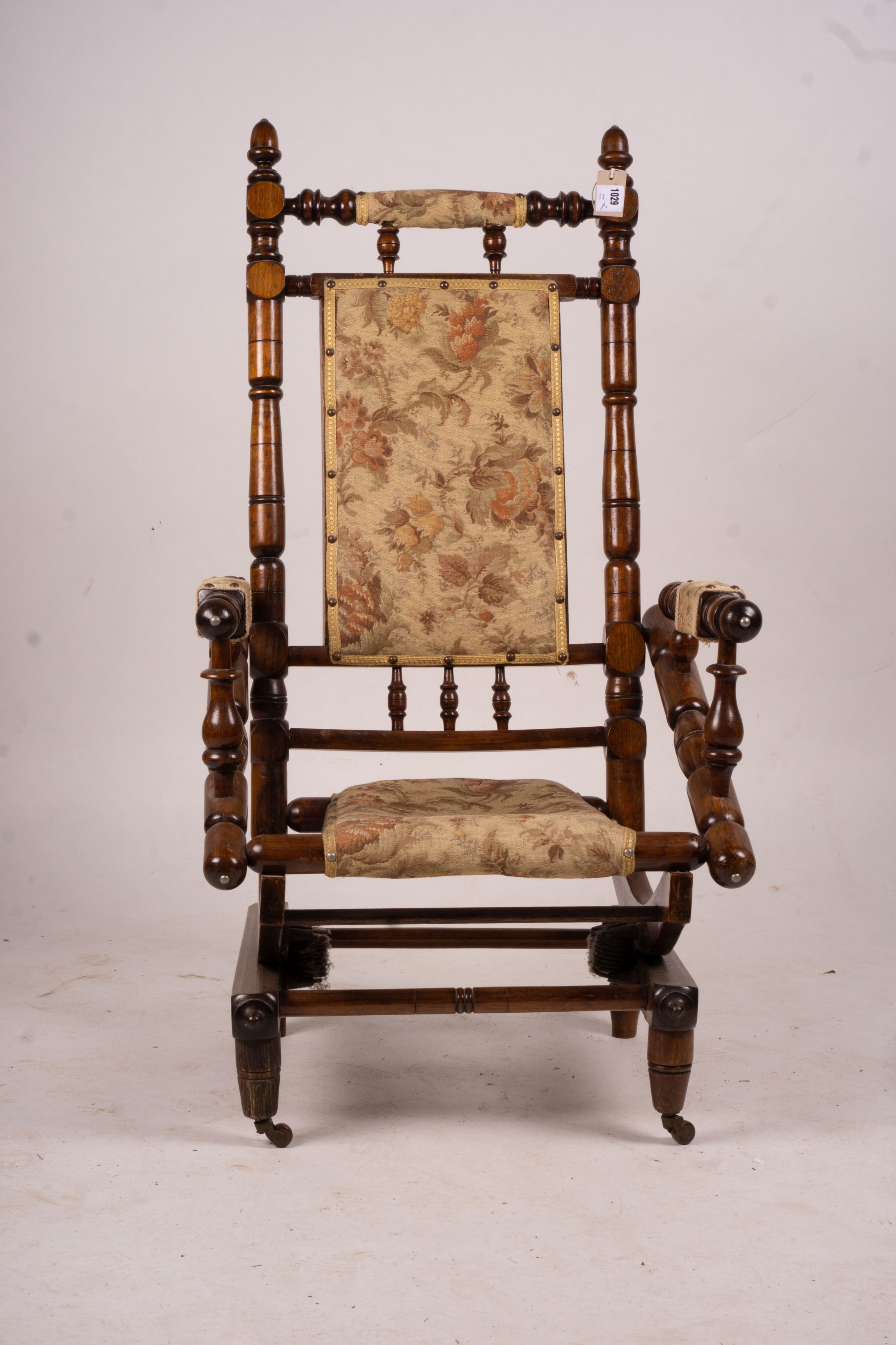 An early 20th century American turned mahogany rocking chair